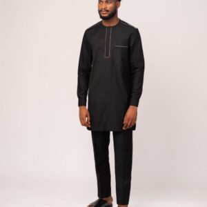 Charcoal grey vest with metallic buttons and red plaid chest pocket, layered over black shirt and matching black trousers.