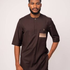 Dark brown long top with beige pocket detail, paired with beige trousers and black sandals.